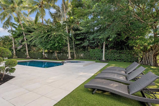 view of pool with an in ground hot tub and a patio