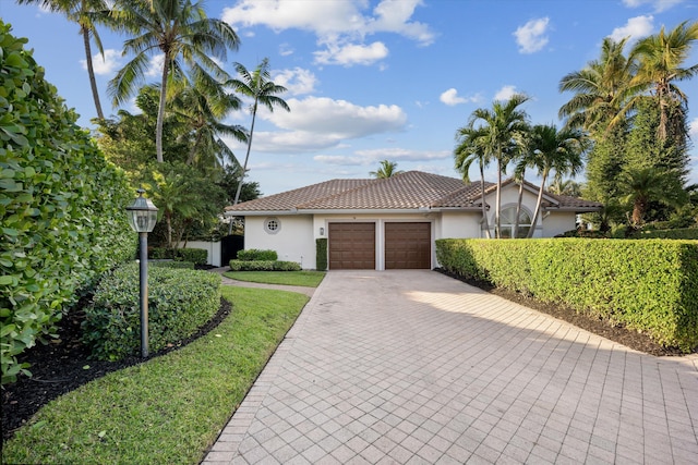 mediterranean / spanish house featuring a garage