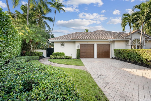 mediterranean / spanish-style house with a garage