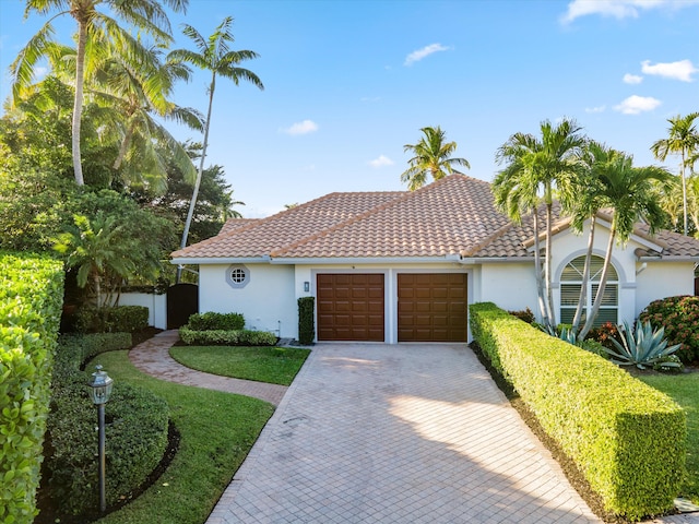 mediterranean / spanish home featuring a garage