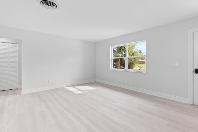 unfurnished room with light wood-type flooring