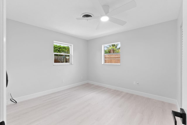 unfurnished room featuring plenty of natural light, light hardwood / wood-style floors, and ceiling fan