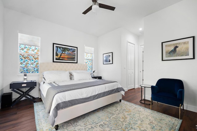 bedroom featuring a closet, dark hardwood / wood-style floors, and ceiling fan