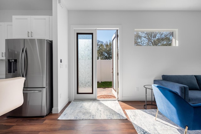 kitchen featuring white cabinetry, dark hardwood / wood-style flooring, and stainless steel fridge with ice dispenser