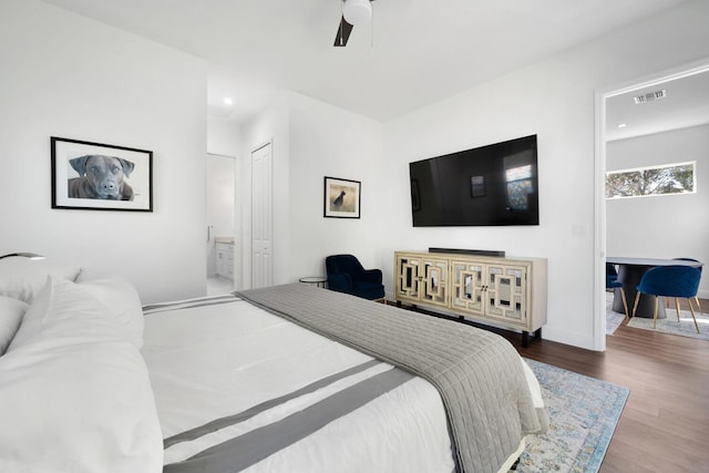 bedroom with ceiling fan, hardwood / wood-style floors, and ensuite bathroom