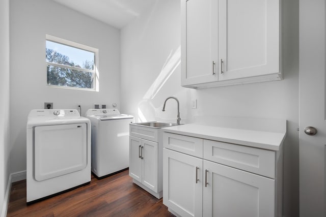 laundry area featuring sink, dark hardwood / wood-style floors, cabinets, and independent washer and dryer