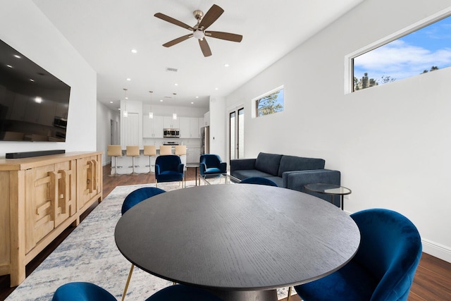 dining space featuring ceiling fan and dark hardwood / wood-style floors