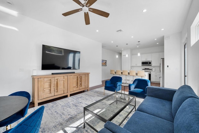 living room featuring hardwood / wood-style flooring and ceiling fan