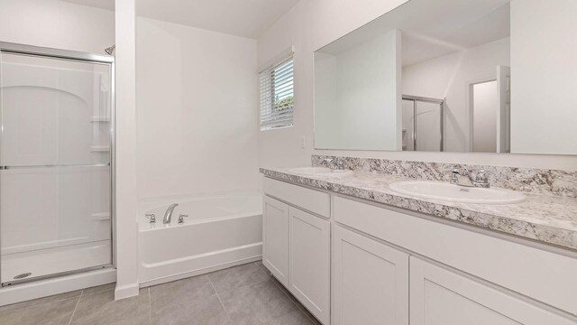 bathroom with tile patterned floors, vanity, and separate shower and tub