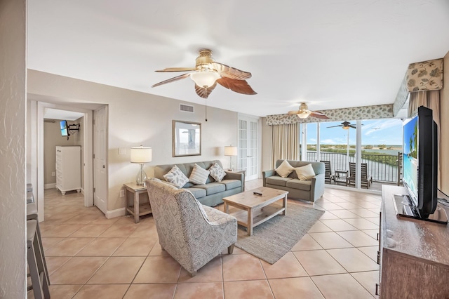 living room with ceiling fan and light tile patterned flooring