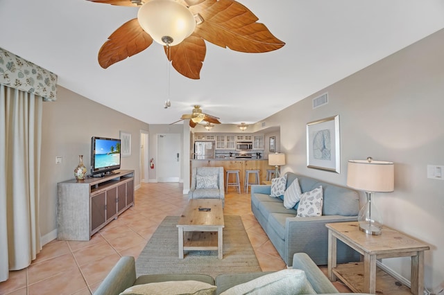 living room with ceiling fan and light tile patterned floors