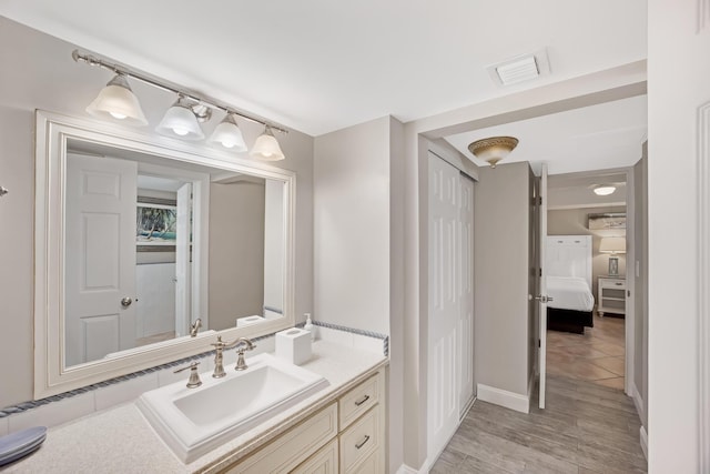 bathroom with vanity and wood-type flooring