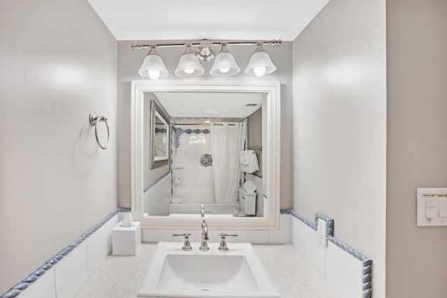 bathroom featuring vanity and shower / bath combo with shower curtain