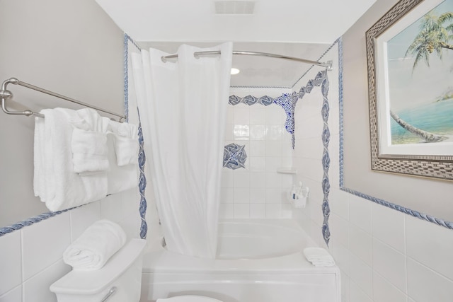 bathroom with tile walls, toilet, and shower / bathtub combination with curtain