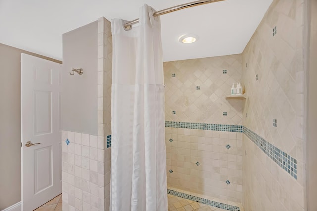 bathroom featuring tile walls, a shower with curtain, and tile patterned flooring