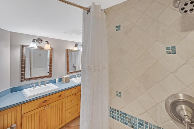 bathroom with walk in shower, vanity, and tile patterned floors