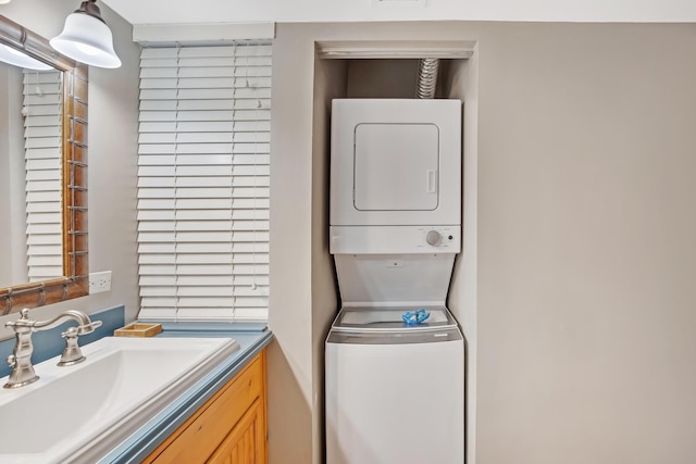 laundry area featuring sink and stacked washing maching and dryer