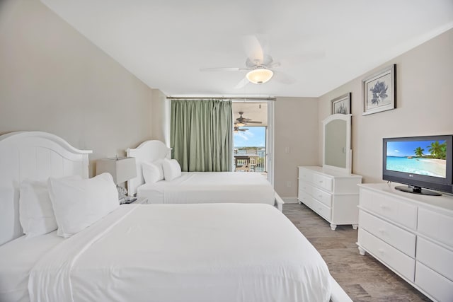 bedroom featuring ceiling fan, access to outside, and dark hardwood / wood-style flooring