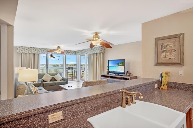 kitchen featuring ceiling fan and sink