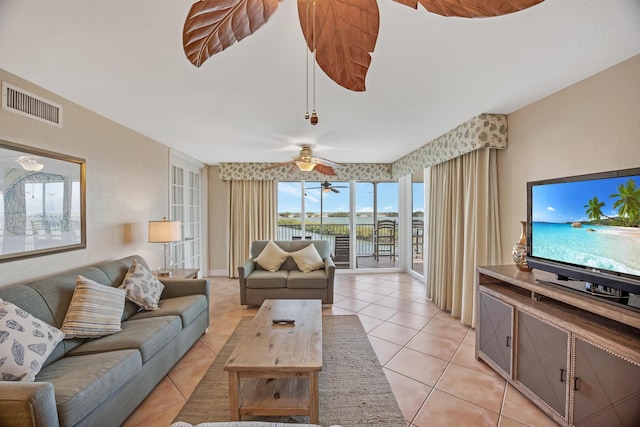 tiled living room with ceiling fan