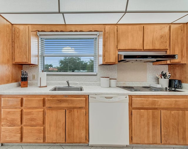 kitchen featuring dishwasher, sink, decorative backsplash, light tile patterned floors, and stovetop