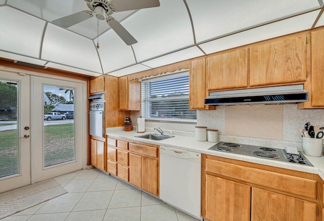 kitchen featuring french doors, tasteful backsplash, white appliances, sink, and light tile patterned flooring