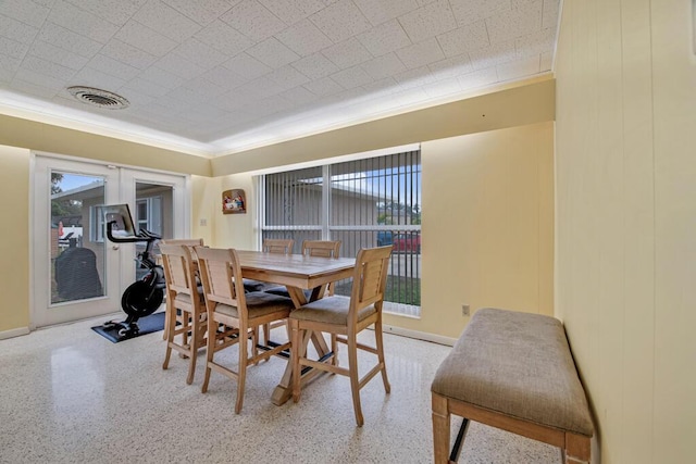 dining area with crown molding and a healthy amount of sunlight