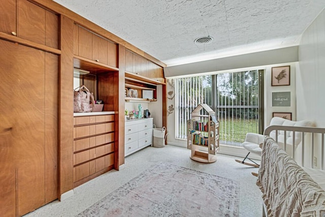 carpeted bedroom with a textured ceiling