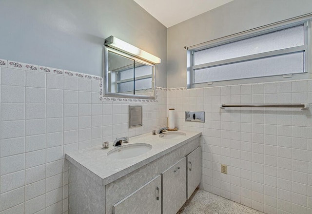 bathroom with vanity and tile walls