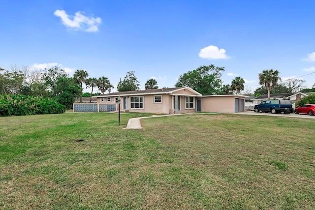 ranch-style home featuring a garage and a front lawn