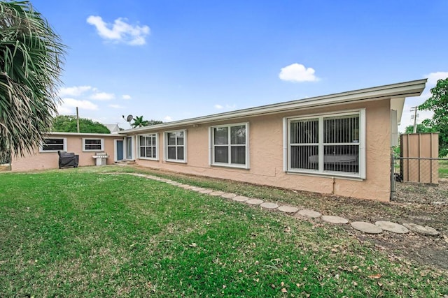 back of property featuring a yard