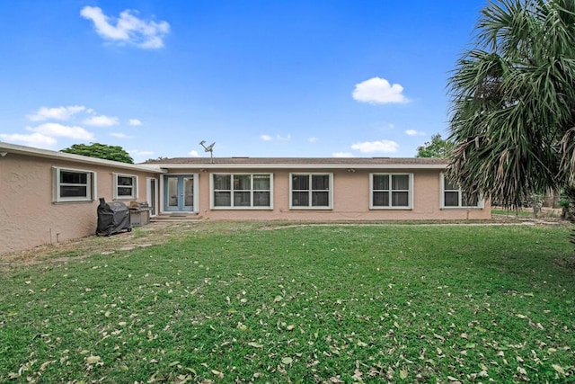 rear view of property featuring a yard