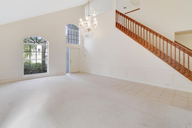 tiled entryway featuring a notable chandelier