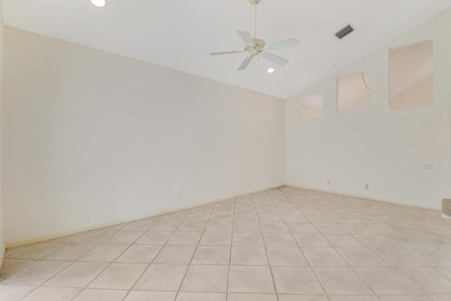 empty room with light tile patterned flooring, ceiling fan, and vaulted ceiling