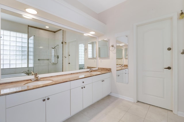 bathroom featuring vanity, tile patterned flooring, and a shower with door