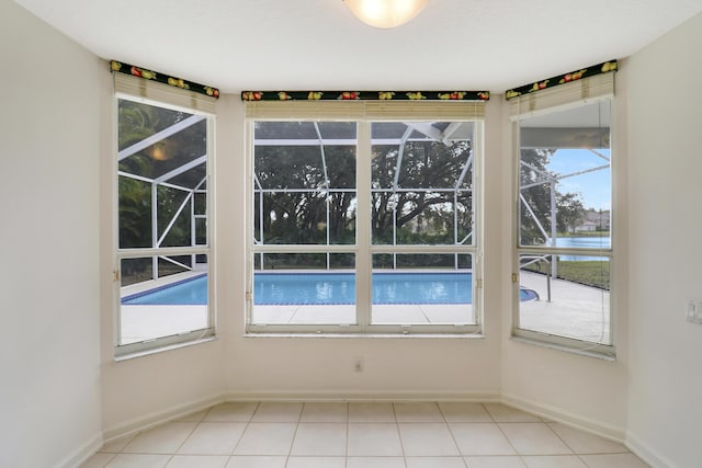 empty room featuring a water view and a healthy amount of sunlight