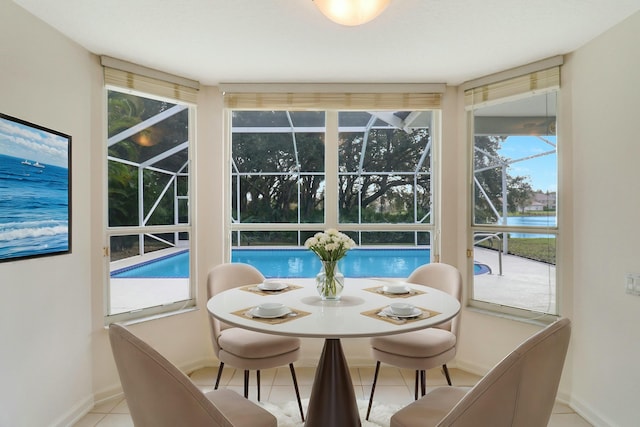 sunroom / solarium with a water view and a healthy amount of sunlight