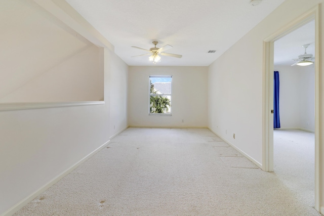 unfurnished room with light carpet and ceiling fan