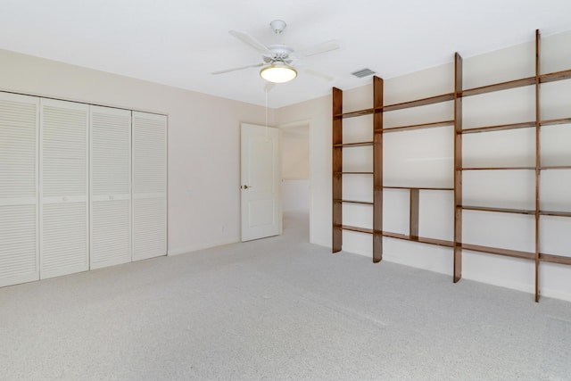 unfurnished bedroom featuring light carpet, ceiling fan, and a closet