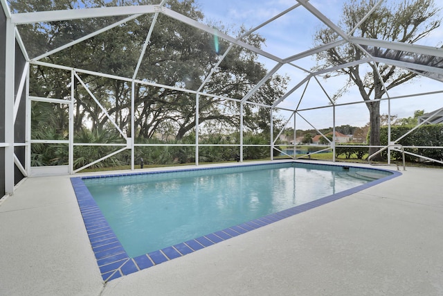 view of pool featuring a patio and glass enclosure