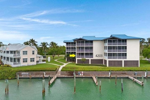 exterior space with a water view and a lawn