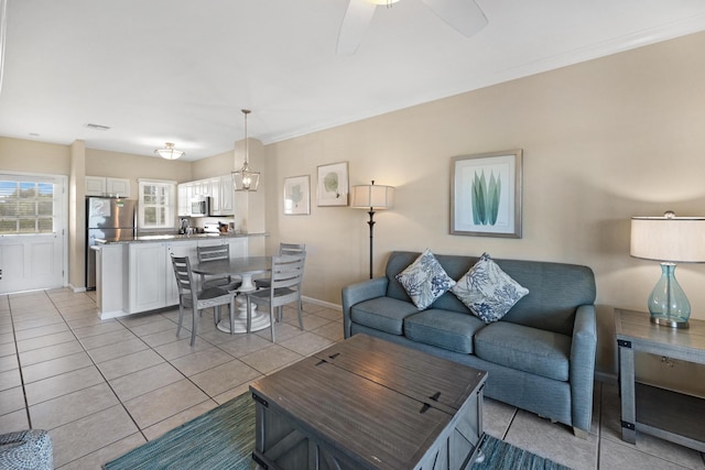 tiled living room with ceiling fan