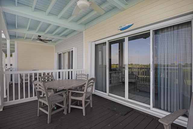 deck at dusk featuring ceiling fan