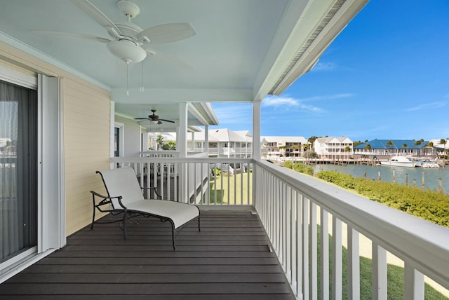 deck featuring ceiling fan and a water view