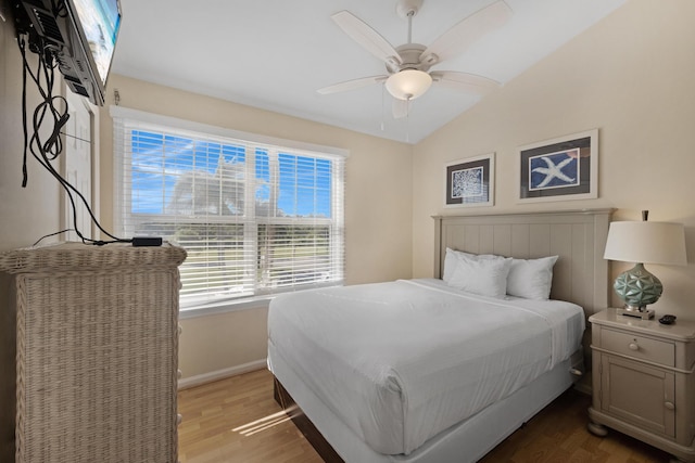 bedroom featuring lofted ceiling, ceiling fan, and light wood-type flooring