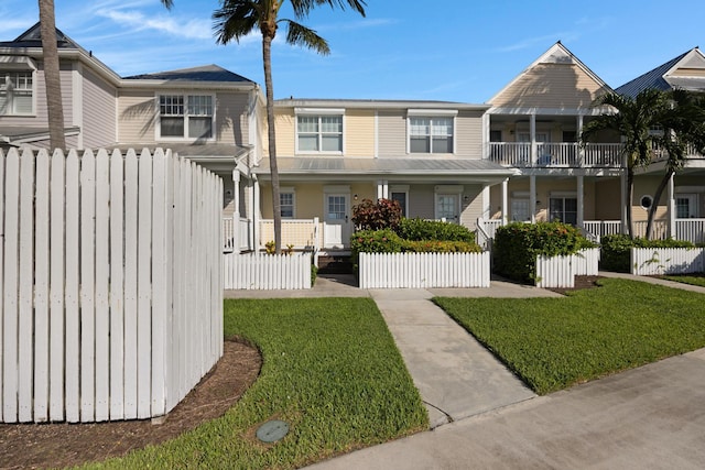 multi unit property with a porch and a front yard