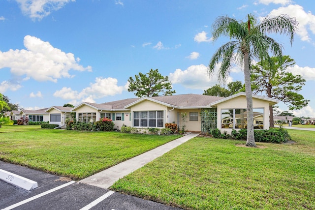 ranch-style home with a front lawn