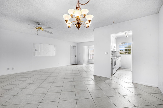 unfurnished living room with light tile patterned floors, ceiling fan with notable chandelier, and a textured ceiling