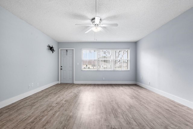 unfurnished room featuring hardwood / wood-style floors, a textured ceiling, and ceiling fan