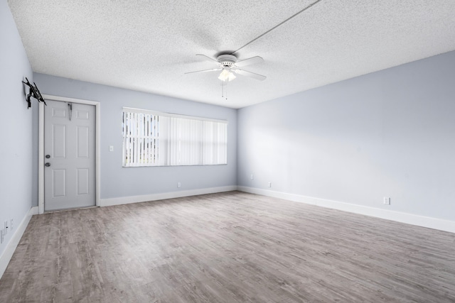 empty room with wood-type flooring, a textured ceiling, and ceiling fan